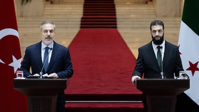 Mr Fidan, left, and Mr Al Shara attend a press conference after their meeting. EPA