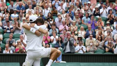 France’s Pierre-Hughes Herbert, left, and Nicolas Mahut, right, embrace as they celebrate beating France’s Julien Benneteau and Edouard Roger-Vasselin to win the men’s doubles final on the thirteenth day of the 2016 Wimbledon Championships at The All England Lawn Tennis Club in Wimbledon, southwest London, on July 9, 2016. Justin Tallis / AFP