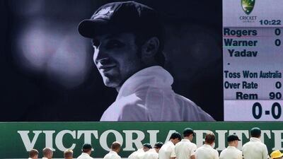 Australia players take a minute's silence to honour Phillip Hughes before the Test match against India in January. William West / AFP