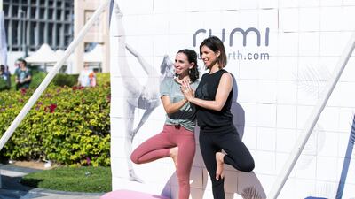 Women take a pose at YOGAFEST.
