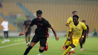 Al Wasl's Siaka Sidibe battles with United's Aniss Karimi.