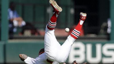 St. Louis Cardinals second baseman Kolten Wong falls as he tries to catch a pop up by Chicago Cubs’ Chris Valaika for a single during the eighth inning of a baseball game in St. Louis. Wong left the game with an injury after the play and the Cardinals went on to win 9-6. Jeff Roberson / AP