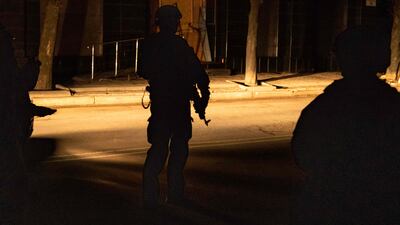 A Ukrainian special forces member stands in a street in Kharkiv. AFP