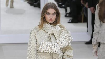 Model Gigi Hadid, centre, wears a creation as part of Chanel’s Fall-winter 2016-2017 ready to wear collection presented in Paris, France, Tuesday, March 8, 2016. AP Photo/Francois Mori