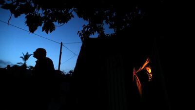 A Palestinian woman looks out of her dwelling in Beit Lahiya town in the northern Gaza Strip. Mohammed Salem / Reuters