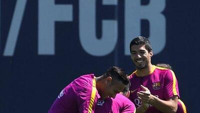 Barcelona’s Brazilian forward Neymar (L), Barcelona’s Argentinian forward Lionel Messi (C) and Barcelona’s Uruguayan forward Luis Suarez (R) joke during a training session at the Sports Centre FC Barcelona Joan Gamper in Sant Joan Despi, near Barcelona on April 16, 2016, on the eve of the final of the Copa del Rey match between FC Barcelona and Sevilla FC. Lluis Gene / AFP