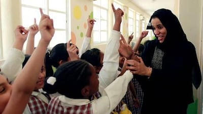 Inside or outside the school, people wave to Ms Al Ari in recognition. When she enters a classroom, the girls stand up out of respect.