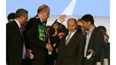 The head of the National Transitional Council, Mustafa Abdul Jalil, centre, waves upon his arrival at Mitiga airport in Tripoli. Anis Mili / Reuters