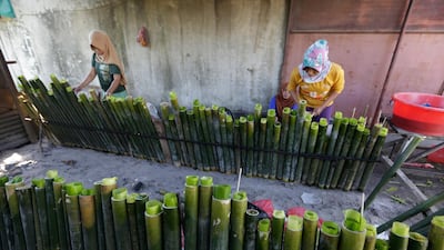 Women prepare Lemang - a favourite Acehnese food for breaking fast. EPA