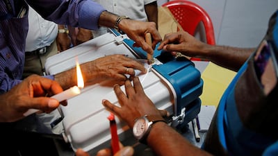Polling officials seal a Voter Verifiable Paper Audit Trail machine at a polling station after the end of the third phase of the general election in Kochi. Reuters