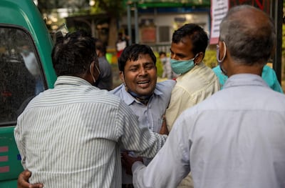 Family members mourn after a man is declared dead amid a surge in coronavirus cases in India. Reuters