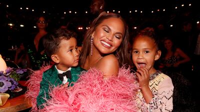 Teigen changed into a second dress with pink feathered sleeves; seen here with children, Miles Stephens and Luna Stephens. Getty Images