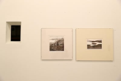 The gallery cut a window (left) through the wall from the exhibition area into the offices, so exhibtion-goers can see the dealers at work. On the right, two prints from the Lahore artist Mehreen Murtaza. Pawan Singh / The National