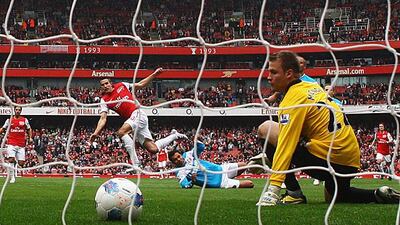 Robin van Persie, the Arsenal captain and striker, slots a shot past Simon Mignolet, the Sunderland goalkeeper, to open the scoring at the Emirates Stadium. Julian Finney / Getty Images