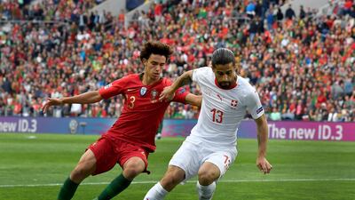 Portugal's Joao Felix, left, and Switzerland's Ricardo Rodriguez, right, challenge for the ball during the UEFA Nations League semifinal. AP Photo