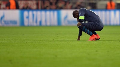 FC Porto's Jackson Martinez kneels dejected on the pitch after losing to Bayern Munich in the Champions League quarter-final second leg on Tuesday. Andreas Gebert / EPA