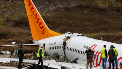 Officials work on the wreckage of a plane operated by Pegasus Airlines after it skidded Wednesday off the runway at Istanbul's Sabiha Gokcen Airport, in Istanbul. AP Photo