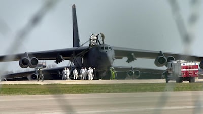 Air and firecrew work on one of the American B-52 High altitude bombers currently based at RAF Fairford, Gloucestershire, March 14, 2003. AFP