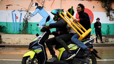 A motorbike rides past a mural of England wicketkeeper Jos Buttler painted on the walls surrounding the Himachal Pradesh Cricket Association Stadium in Dharamsala, India. Getty Images