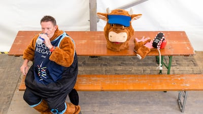 A man in a mascot costume cools down in the shade at the World Rowing Cup at Rotsee lake in Lucerne, Switzerland. EPA