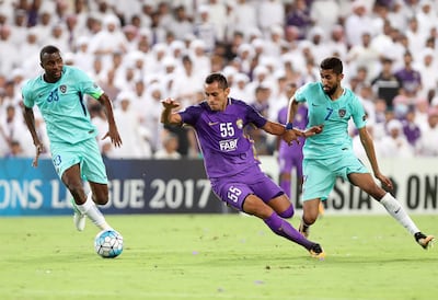 Al Ain striker Douglas and Al Hilal's Salman Alfaraj, right. Chris Whiteoak / The National
