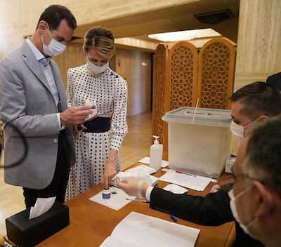 Bashar Al Assad and his wife Asma at a polling station in Damascus on July 19. AFP / Syrian Presidency Facebook page