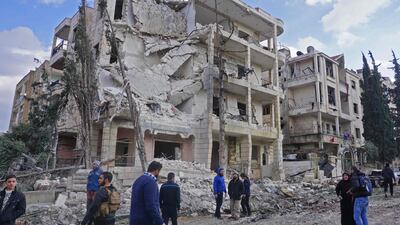 Syrians gather at the scene of a double attack in Syria's north-western city of Idlib, which is controlled by Hayat Tahrir Al Sham. AFP / Muhammad Haj Kadour
