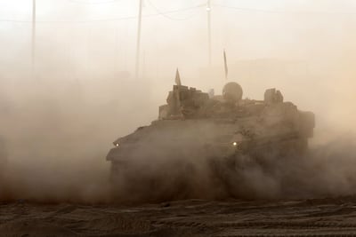 An Israeli armoured personnel carrier rolls at a position near the border with the Gaza Strip on July 21, 2025. AFP