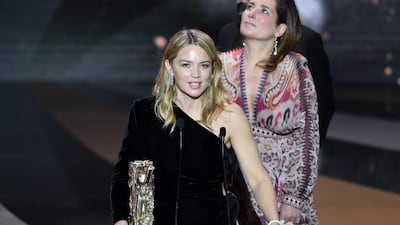 Belgian actress Virginie Efira accepts the Best Director award on behalf of French actor and film director Albert Dupontel for the movie 'Adieu les cons' (Bye Bye Morons) during the 46th edition of the Cesar Film Awards ceremony at The Olympia concert venue in Paris, France. AFP