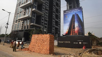 Indian labourers work on the road leading to the under-construction Trump Tower in Kolkata. Dibyangshu Sarkar / AFP