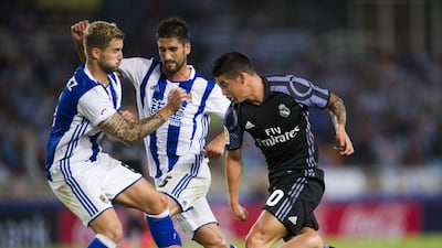 James Rodriguez of Real Madrid duels for the ball with Joseba Zaldua of Real Sociedad. (Juan Manuel Serrano Arce/Getty Images)