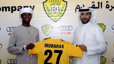 Wasl chairman Marwan bin Bayat, right, unveils Mubarak Hassan as the club's latest signing.