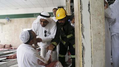 A man wounded in a suicide attack on the Shiite Imam Ali mosque during Friday prayers in eastern Saudi Arabia, is attended to by civil defence and medics. EPA
