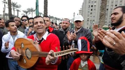 A musician performs during a demonstration in Tahrir Square. The protests, which saw tens of thousands of people massing daily in central Cairo for demonstrations that at times turned violent, have raised questions about the impact on the economy.