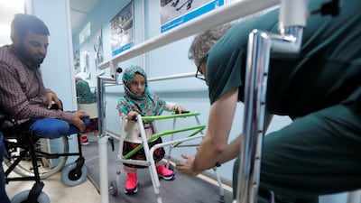 Maya Merhi practises walking with her new artificial legs at a prosthetic centre in Istanbul, Turkey, on July 5, 2018. Reuters