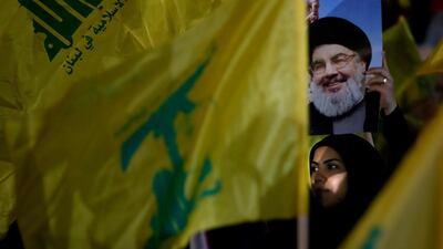A Hezbollah supporter holds up a portrait of Hezbollah leader Sayyed Hassan Nasrallah, during a rally marking the 12th anniversary of the 2006 Israel-Hezbollah war, in Beirut, Lebanon, Tuesday, Aug. 14, 2018. AP