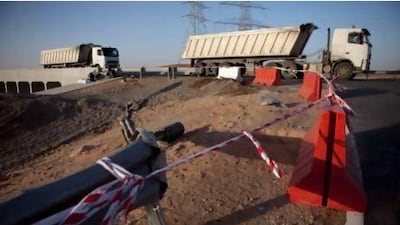 Traffic flows by a scene of the tragic traffic accident on Old Truck Road in Al Ain, involving a truck and a bus full of labourers, which left 22 people dead. Silvia Razgova / The National