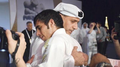 Omar Al Fadhli is congratulated UAEJJF chairman Abdulmunam Al Hashemi after completing his double at the JJIF World Championship in Abu Dhabi on Saturday. Pictures courtesy Shivanna Gowda
