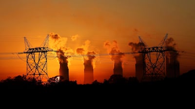 Electricity pylons are seen in front of the cooling towers at the Lethabo Thermal Power Station,an Eskom coal-burning power station near Sasolburg in the northern Free State province. State-owned utility Eskom Holdings, which relies on coal for 80% of its power output, has battled to keep pace with demand since 2005. REUTERS