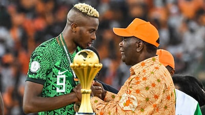 Nigeria forward Victor Osimhen speaks with President of Ivory Coast Alassane Ouattara at the end of the Africa Cup of Nations final. AFP