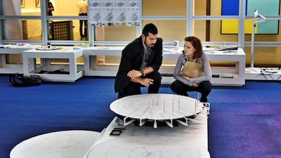 An exhibitor, left, explains his project to a visitor to the Global Grad Show. Shruti Jain / The National