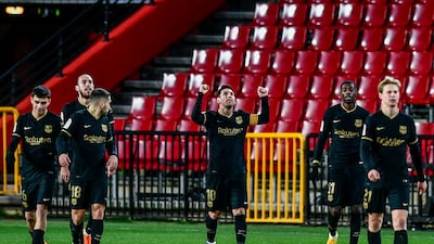 Messi celebrates after scoring his side's third at Granada. AP