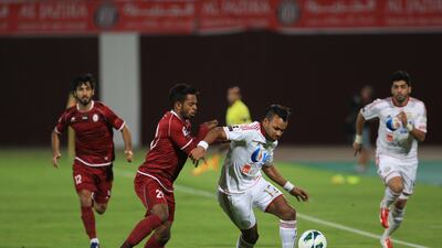 Khalid Jalal shieldsthe ball from Wahda's Abdulla Jasem. Ravindranath K / The National