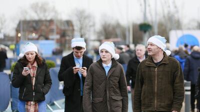 Manchester City fans in blue Christmas hats arrive on Saturday for the Premier League match against Sunderland at the Etihad Stadium. Jason Cairnduff / Action Images / Reuters