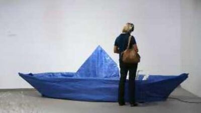 Elizabeth Monoian and Robert Ferry replicate boats they have found at construction sites in World's Largest Blue Tarp Origami Boat .