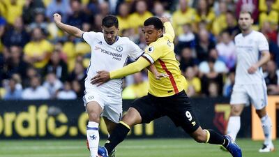 Chelsea forward Eden Hazard tries to take the ball around Troy Deeney. Hannah McKay / Reuters