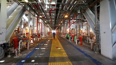An oil worker walks along the deck aboard the Agbami floating production, storage and offloading vessel. George Osodi / Bloomberg