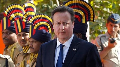 David Cameron, the British prime minister, pays tribute at the Police Memorial in Mumbai on Monday during the first day of a three-day visit. Rajanish Kakade / AP Photo