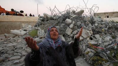 Maha, the mother of 15-year Murad Ideis, who was accused of fatally stabbing an Israeli settler in January, stands next to the rubble of her home in the West Bank village of Beit Amra, south of Hebron on June 11, 2016. Hazem Bader /AFP