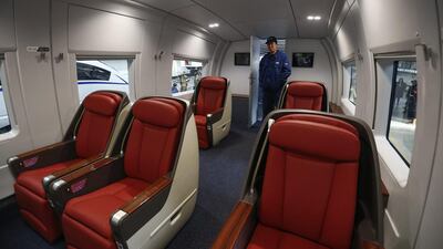 A train driver walks into a passenger seating area of a high-speed train being tested inside the Tangshan Railway Vehicle facility in Hebei province. Rolex Dela Pena / EPA